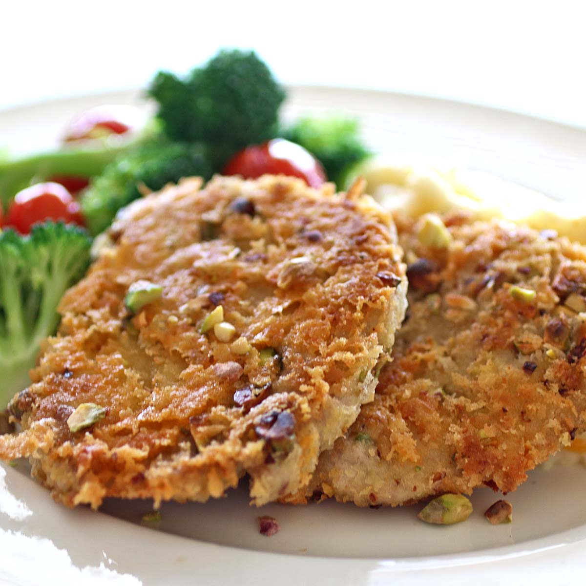 Cheesy Pistachio Pork Tenderloin with Grilled Broccoli and Grape Tomatoes